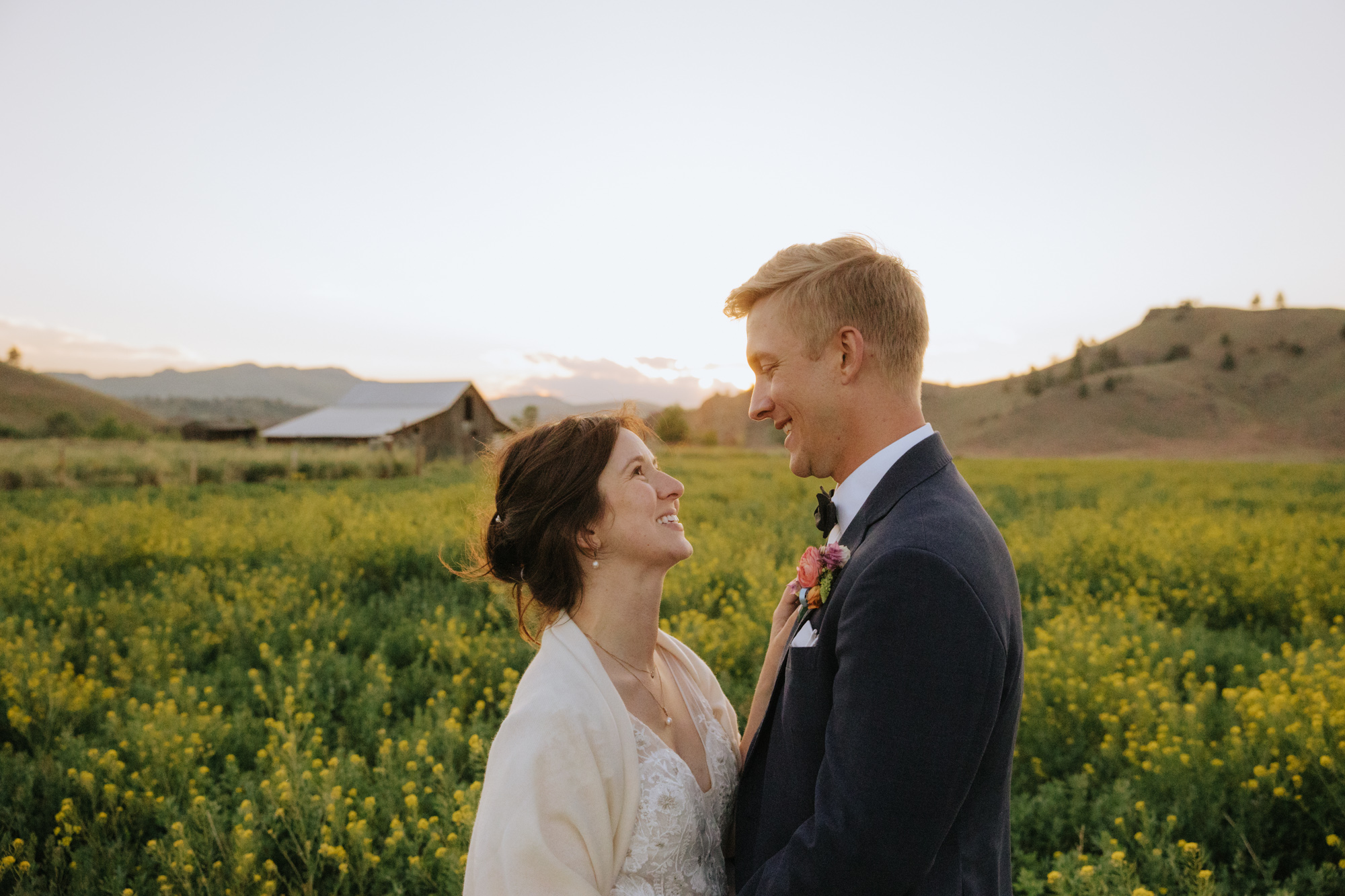 Bride and groom in a field of yellow wildflowers at a private estate wedding in Helena, Montana.