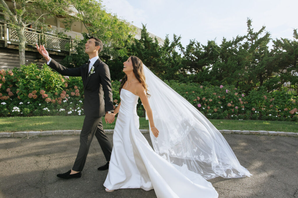 Couple walks hand-in-hand during their Bridgehampton Tennis & Surf Club wedding in Bridgehampton.