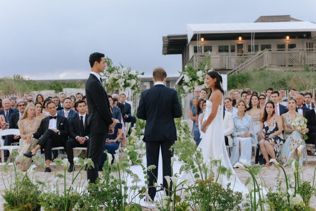 Wedding ceremony on the beach at Bridgehampton Tennis & Surf Club in Bridgehampton, New York.
