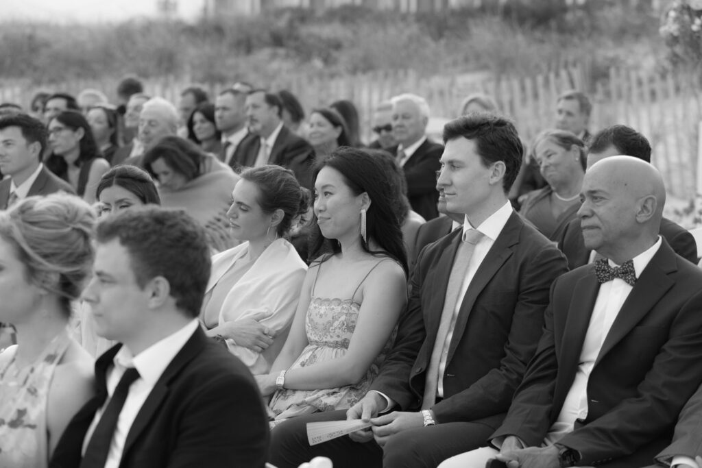 Wedding guests seated in rows during a Bridgehampton Tennis & Surf Club wedding ceremony.