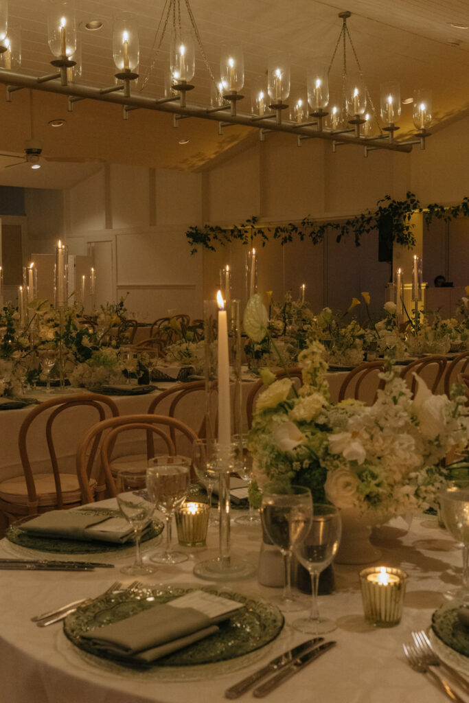 Candles and floral centerpieces adorn tables set for a Bridgehampton Tennis & Surf Club wedding reception.