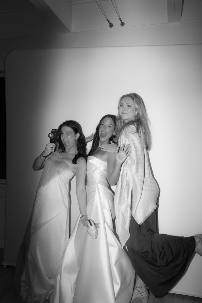 Three guests posing for a photo at a Bridgehampton Tennis & Surf Club wedding in Bridgehampton, NY.