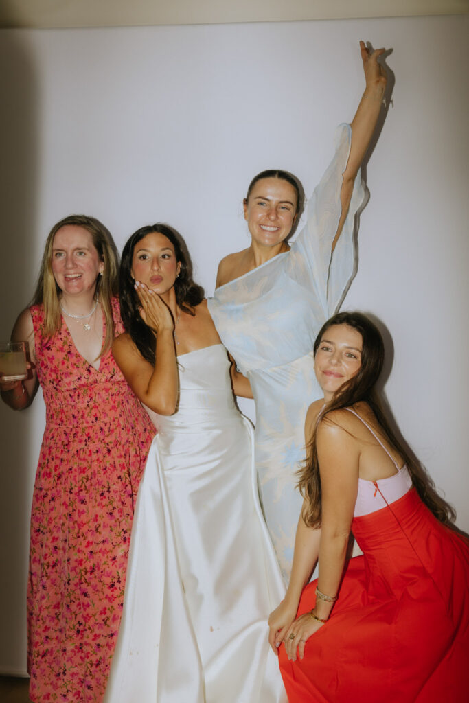 Four women pose for a picture at a Bridgehampton Tennis & Surf Club wedding reception in New York.