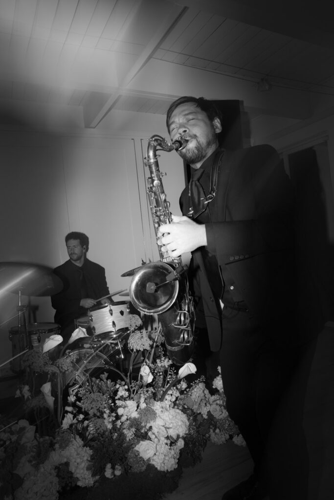 A saxophonist plays on stage during a Bridgehampton Tennis & Surf Club wedding reception in New York.