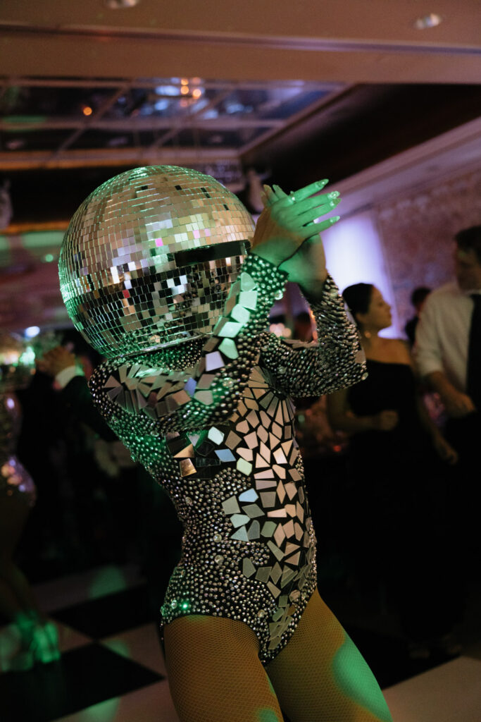 A person in a full disco ball costume performing at a wedding at Russos on the Bay.