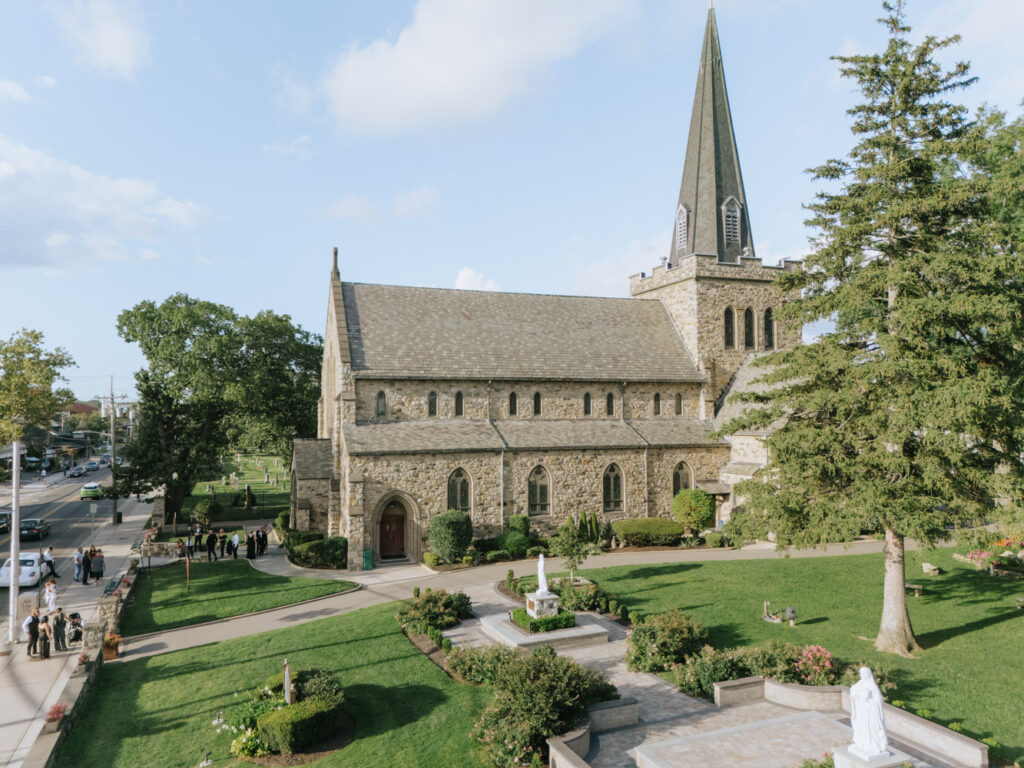 An overhead view of a stone church and grounds, where a Catholic wedding ceremony was held.