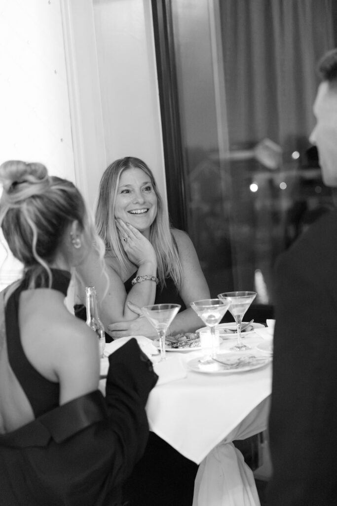 A woman at a Russo's On The Bay wedding reception, smiling at someone off-camera.