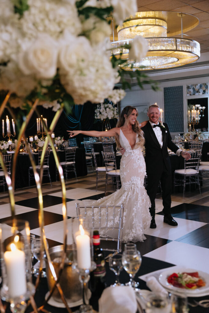 A newlywed couple on a black and white checkered floor at a wedding at Russo's On The Bay.