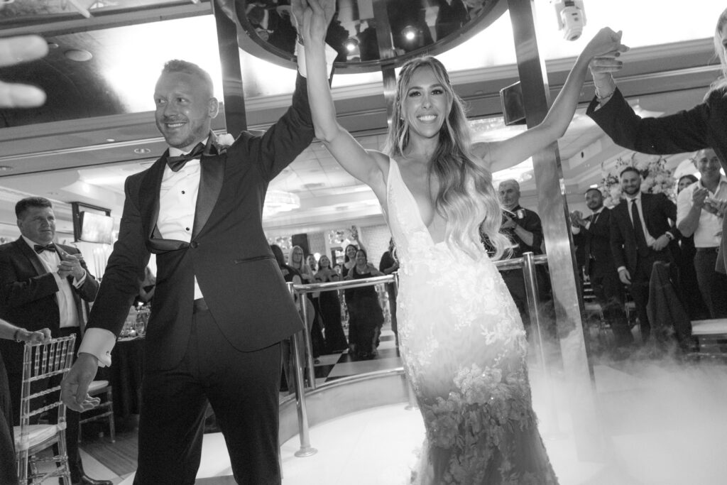 Newlyweds make a grand entrance through smoke at their Russos on the Bay wedding reception.