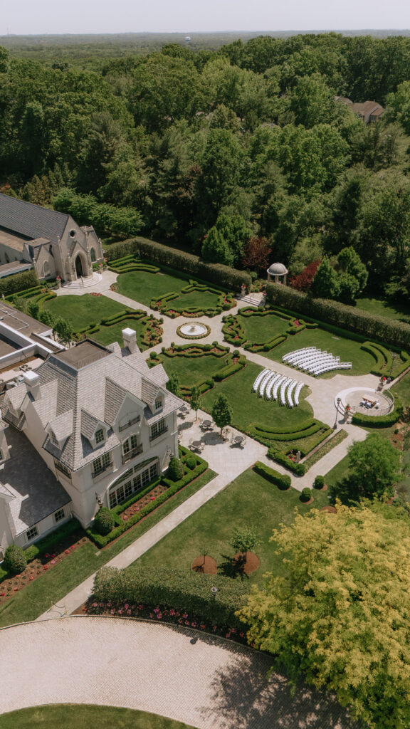 An aerial view shows the Park Chateau Estate & Gardens, with a mansion, chapel, and formal gardens.