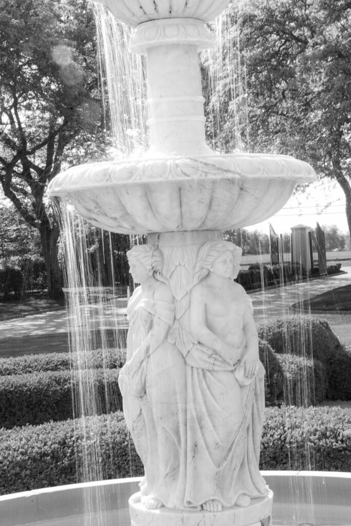 A classical fountain with water streaming down at the Park Chateau in New Brunswick, New Jersey.