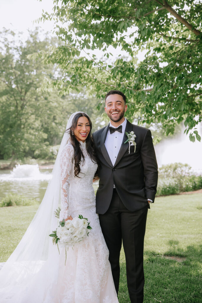 A newlywed couple laughing during their wedding at Park Château Estate & Gardens in East Brunswick, New Jersey.