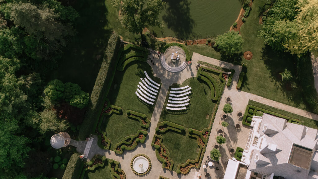 Aerial view of an outdoor wedding ceremony setup in the formal gardens at Park Chateau in New Jersey.