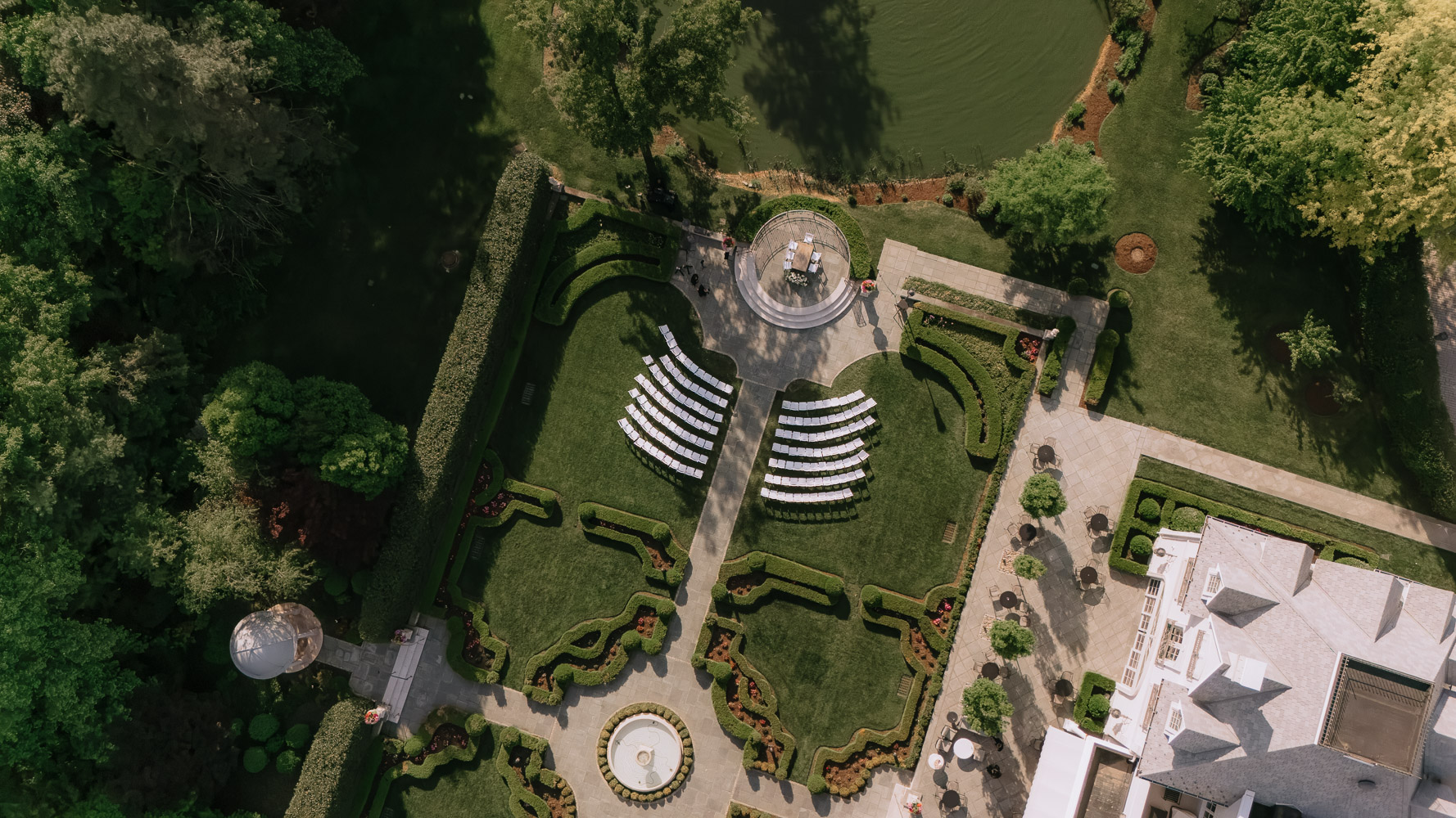 Aerial view of an outdoor wedding ceremony setup in the formal gardens at Park Chateau in New Jersey.