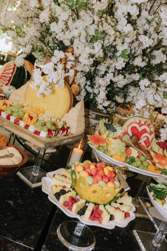 An extravagant food display with cheese, fruit, and bread at a Park Chateau wedding in New Jersey.