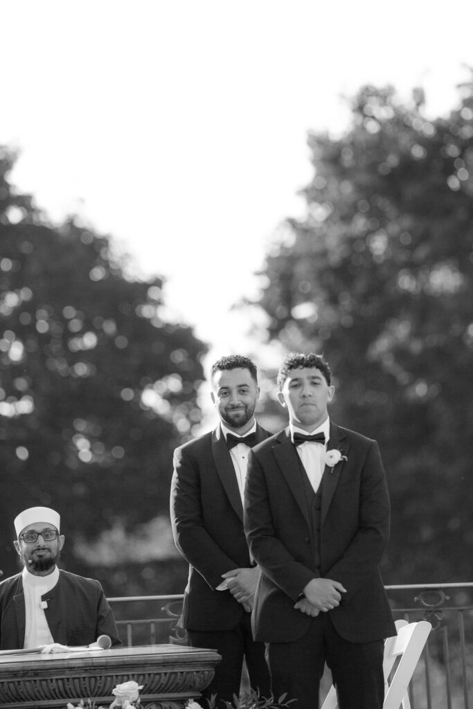 Men in suits observe a Palestinian-Egyptian Muslim wedding ceremony at Park Chateau.