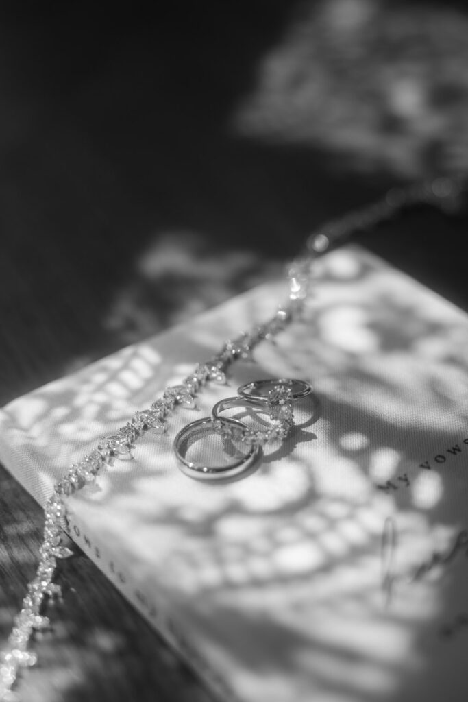 Wedding rings and a diamond bracelet on a "My Vows" book at Park Chateau New Brunswick, New Jersey.