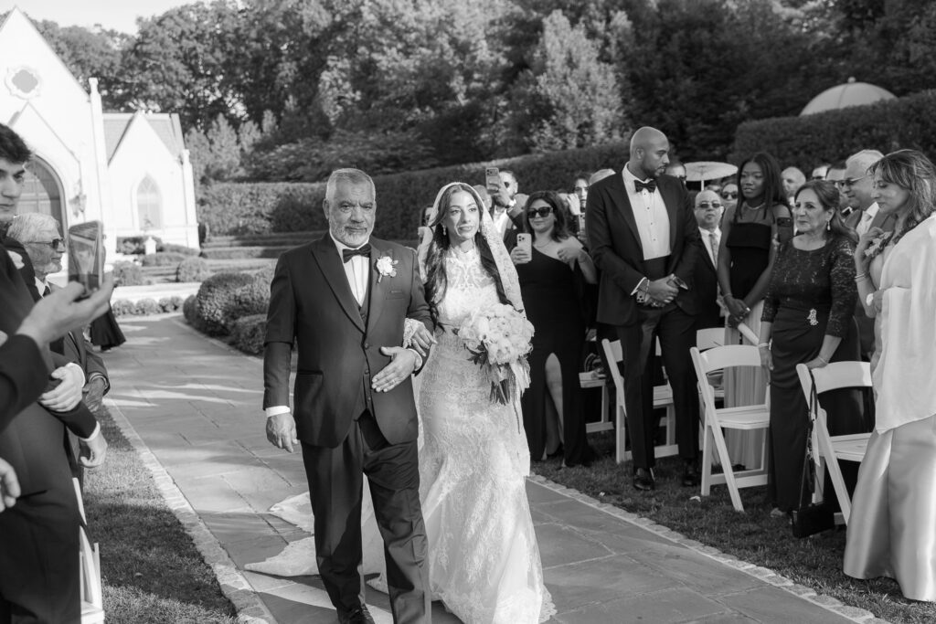 Father walks bride Menah down the aisle at her Park Chateau Estate & Gardens wedding in New Jersey.