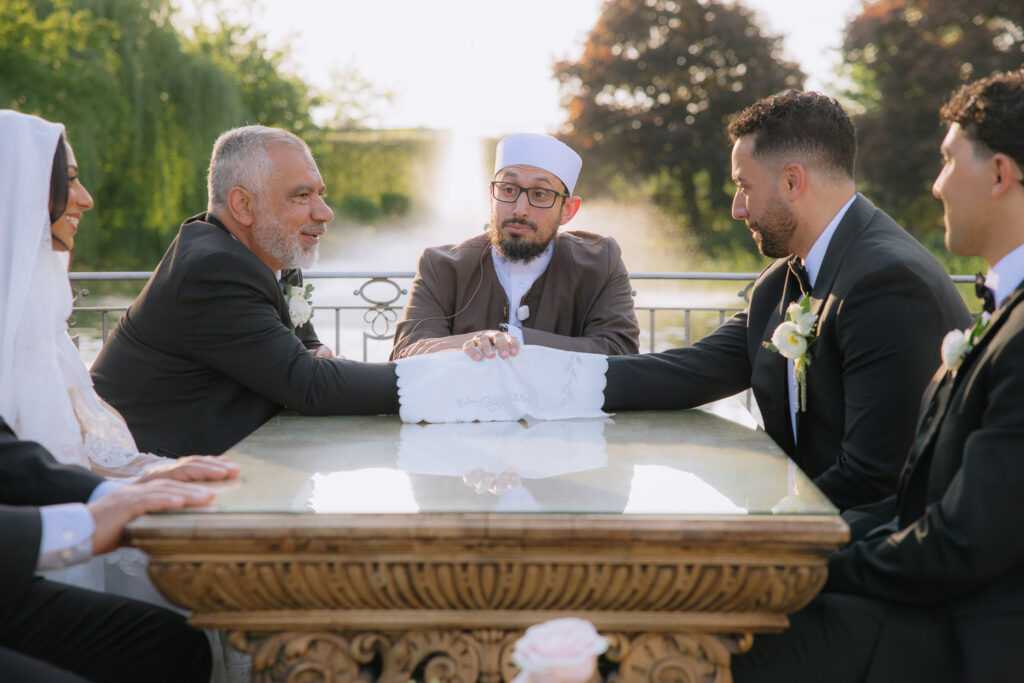A Muslim wedding ceremony with a bride, groom, officiant, and guests at Park Chateau, New Jersey.