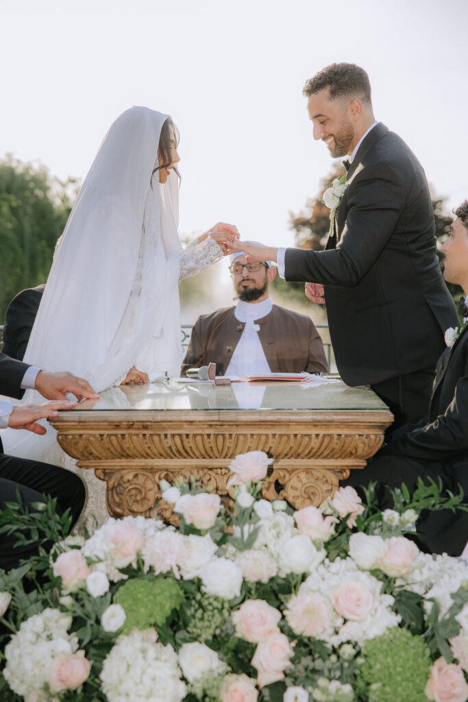 A bride and groom exchanging rings at their Palestinian-Egyptian Muslim wedding at Park Château Estate.