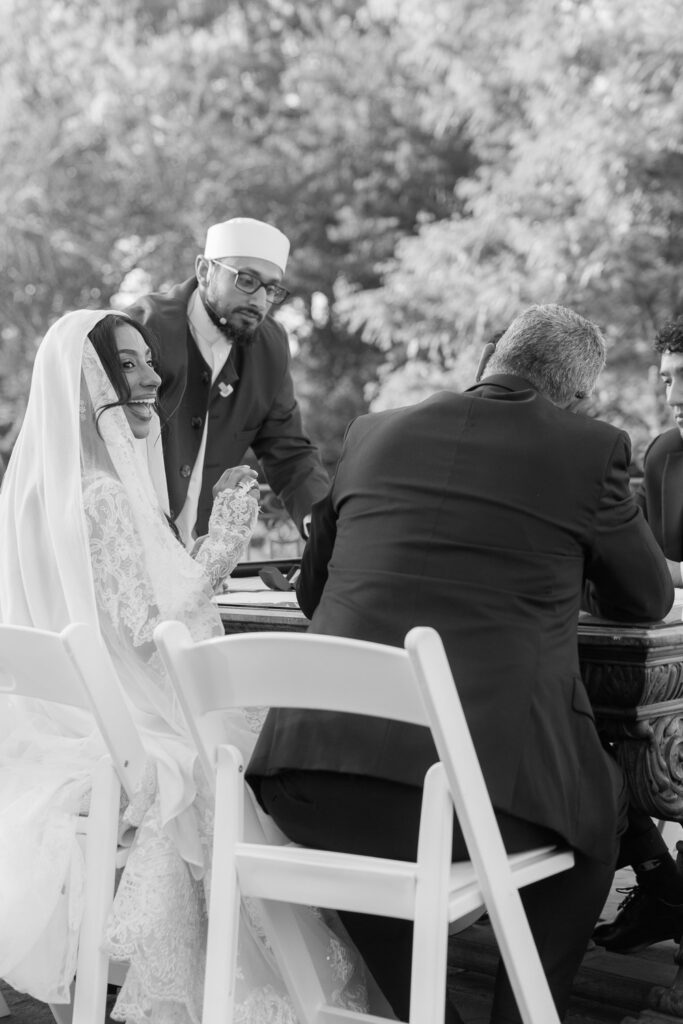 A bride with a hijab smiles during her Palestinian-Egyptian Muslim wedding ceremony at Park Chateau.