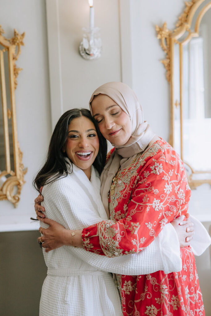 Two women embracing at a Palestinian-Egyptian Muslim wedding at Park Chateau in New Brunswick, New Jersey.