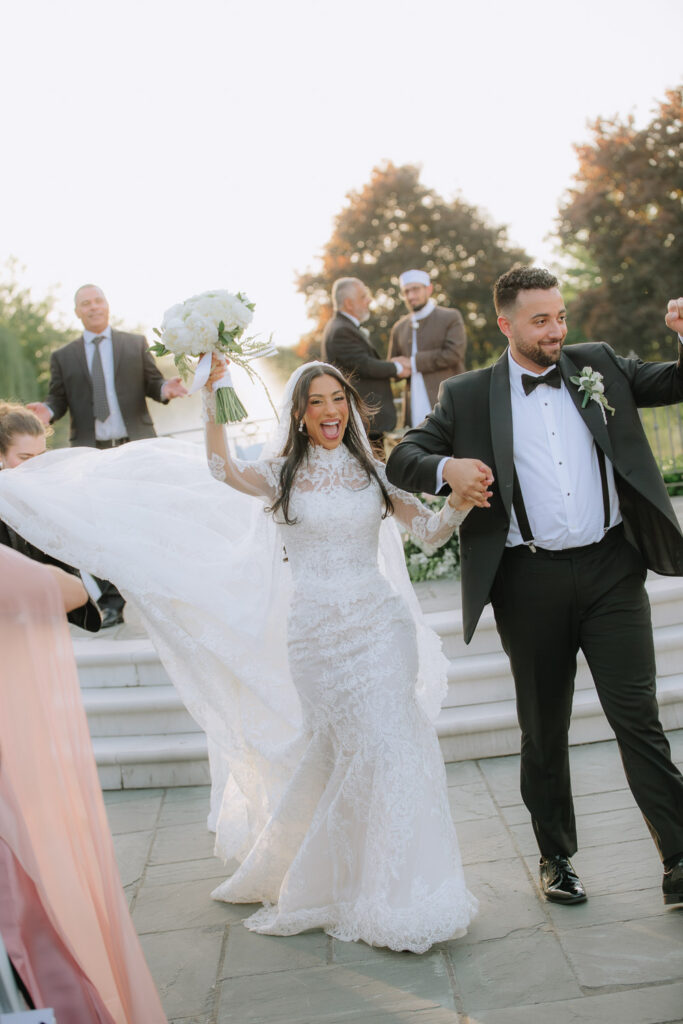 A bride and groom walk together at their Park Chateau Estate wedding in New Brunswick, New Jersey.