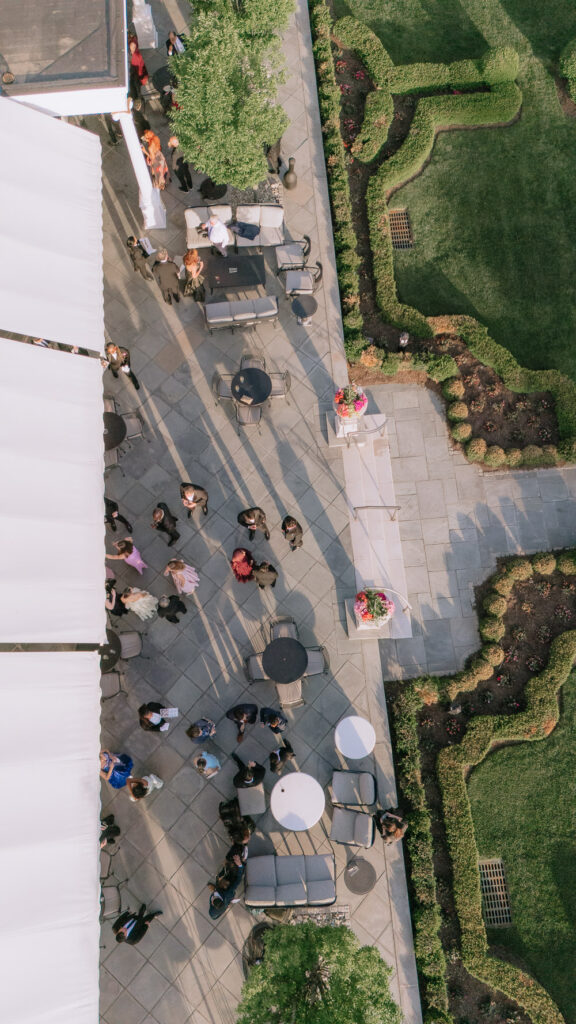 Overhead view of wedding guests gathered on a patio at Park Chateau Estate & Gardens in East Brunswick, New Jersey.