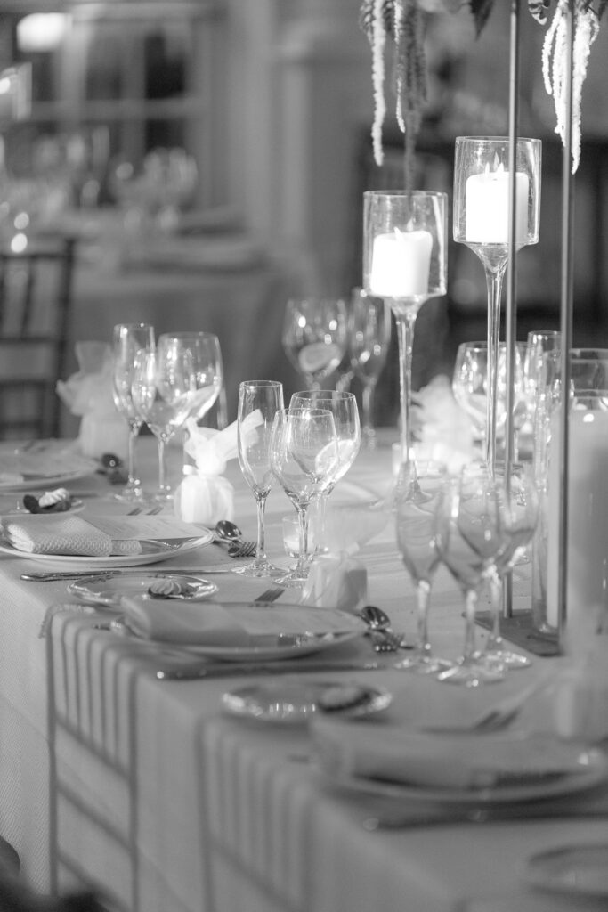 Close-up of a formal wedding reception table set with candles and glassware at Park Chateau.