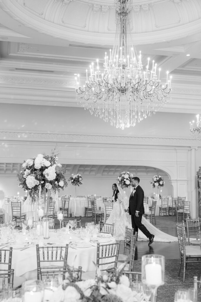 Menah and Ashraf walk through a grand ballroom at their Muslim wedding in Park Chateau.