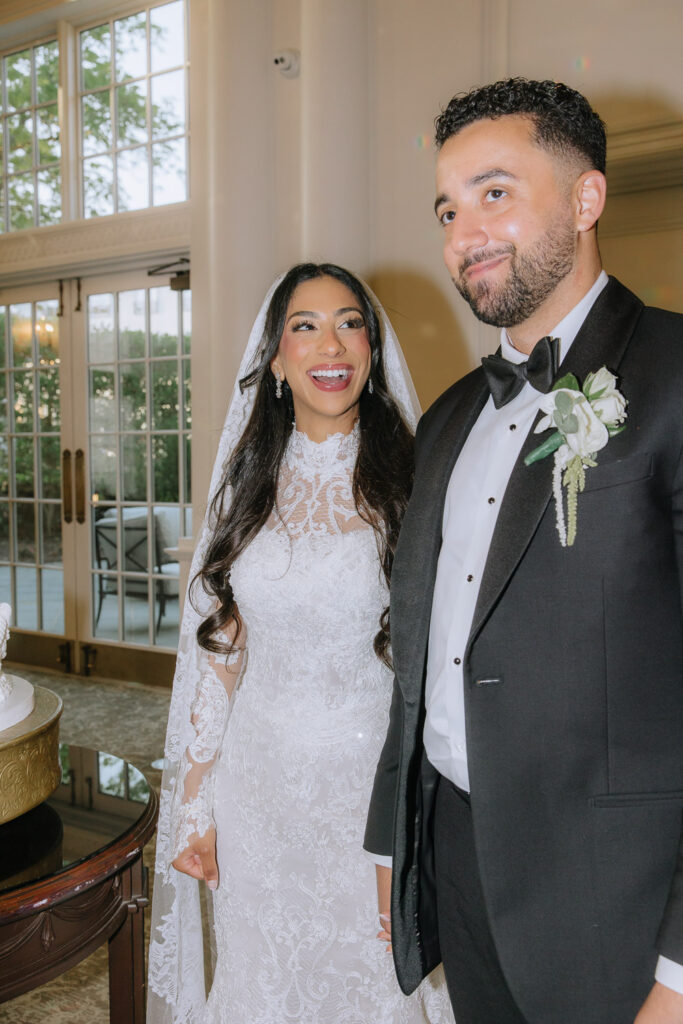Menah and Ashraf, the bride and groom, smiling at their Palestinian-Egyptian Muslim wedding at Park Chateau.