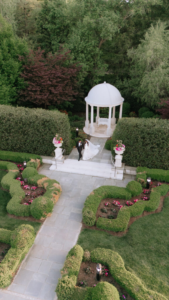 A newlywed couple walks down a staircase at Park Chateau Estate & Gardens in East Brunswick, New Jersey.