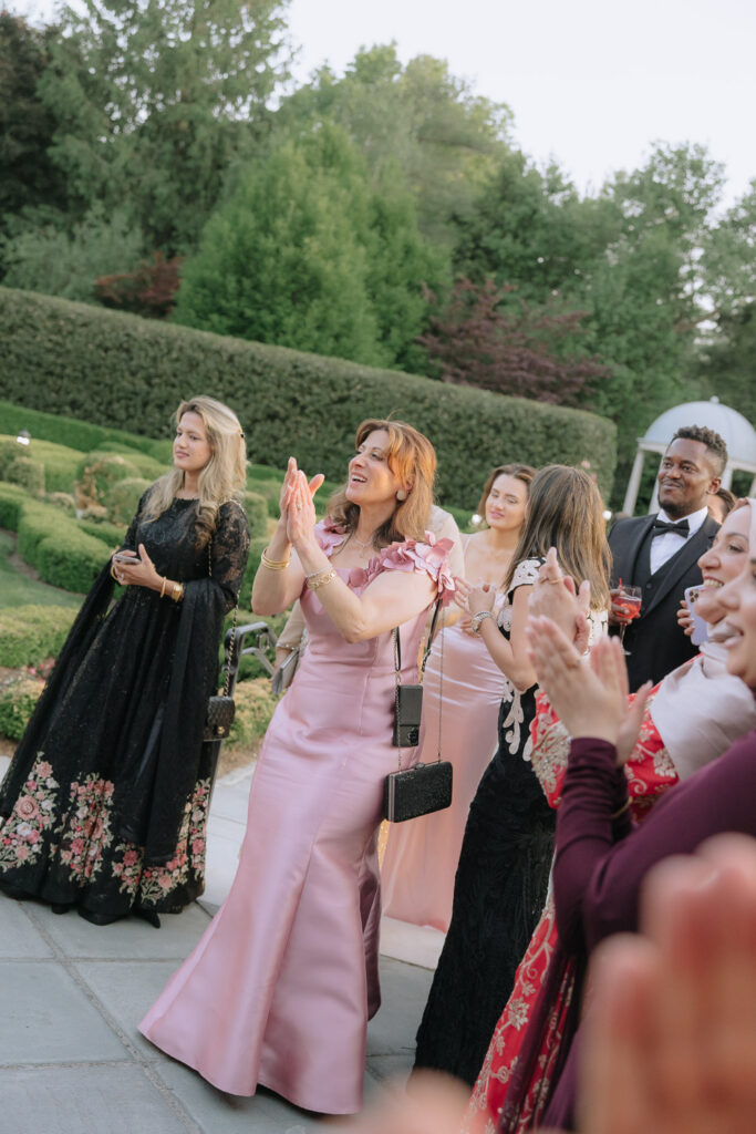 Wedding guests applaud during a Palestinian-Egyptian Muslim wedding at Park Chateau Estate & Gardens, New Jersey.
