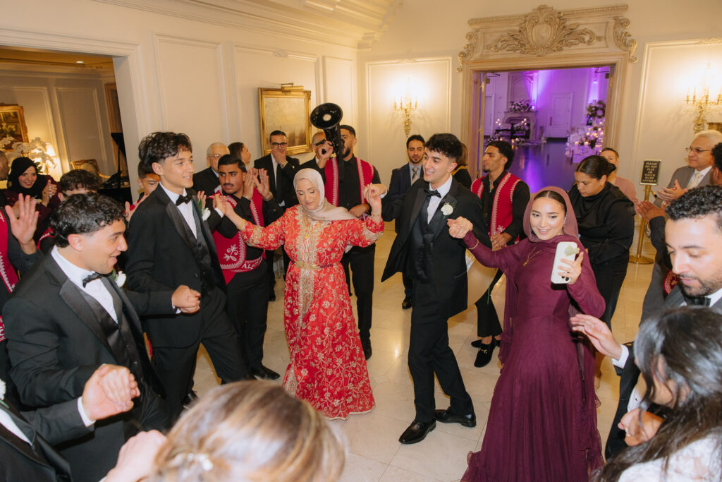 Wedding guests engage in a Zaffa procession dance at Park Chateau Estate & Gardens in East Brunswick, New Jersey.