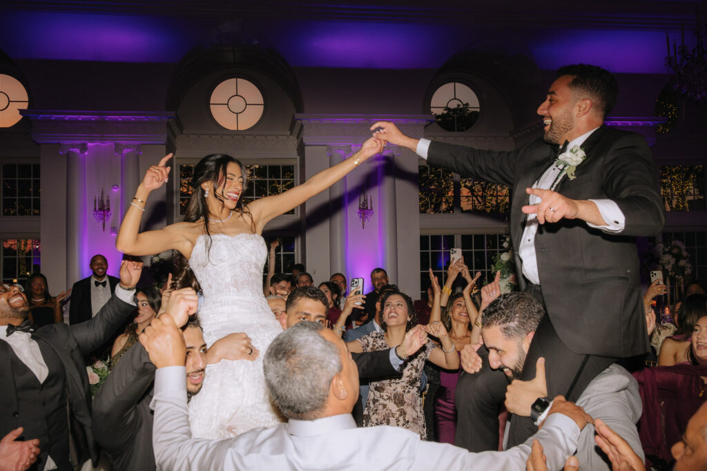 A Palestinian-Egyptian Muslim wedding at Park Château Estate & Gardens with the bride and groom lifted during a Dabke performance.