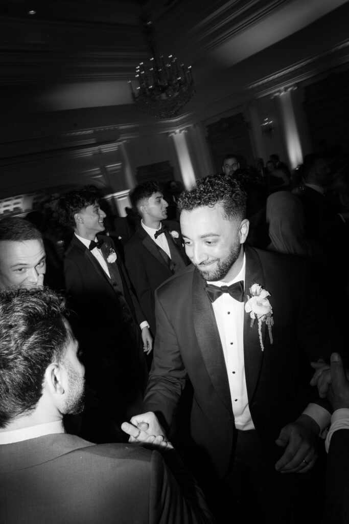 Men dancing in tuxedos at a Palestinian-Egyptian Muslim wedding at Park Château Estate & Gardens.