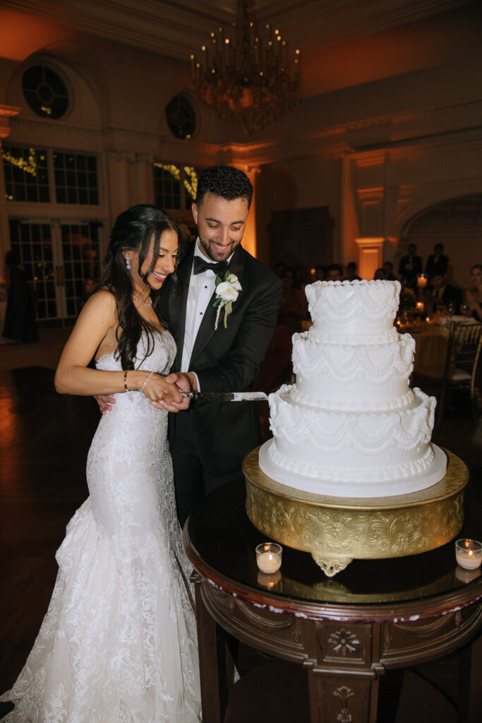 A couple cuts a three-tier wedding cake at a Palestinian-Egyptian Muslim wedding at Park Château.