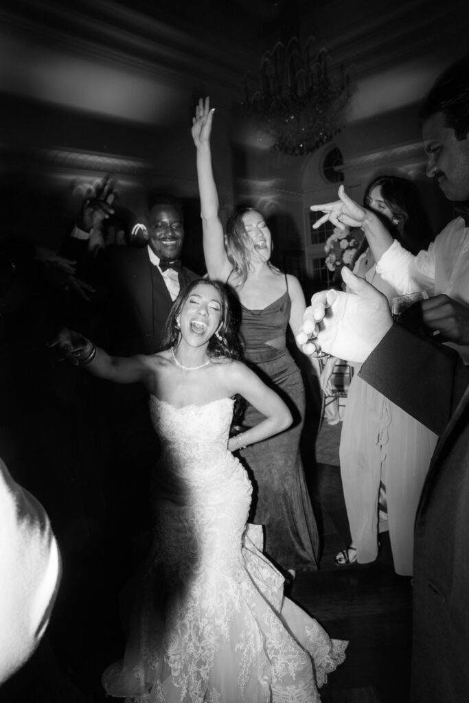 The bride dances with guests on a packed dance floor during a Palestinian-Egyptian Muslim wedding reception at Park Chateau.