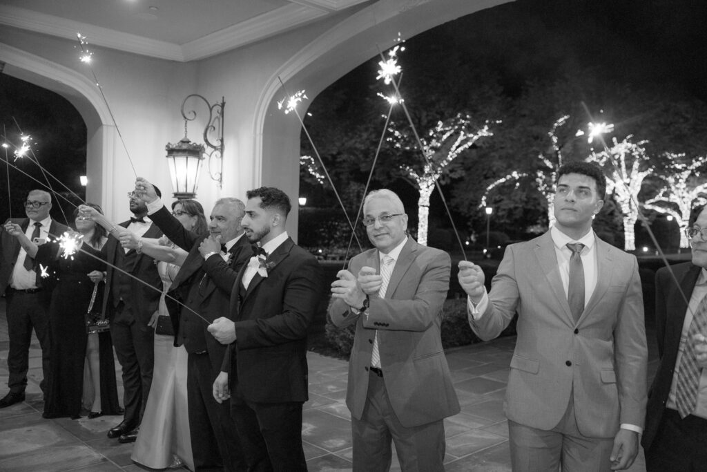 Guests holding sparklers for a grand exit at a Park Chateau wedding in New Brunswick, New Jersey.