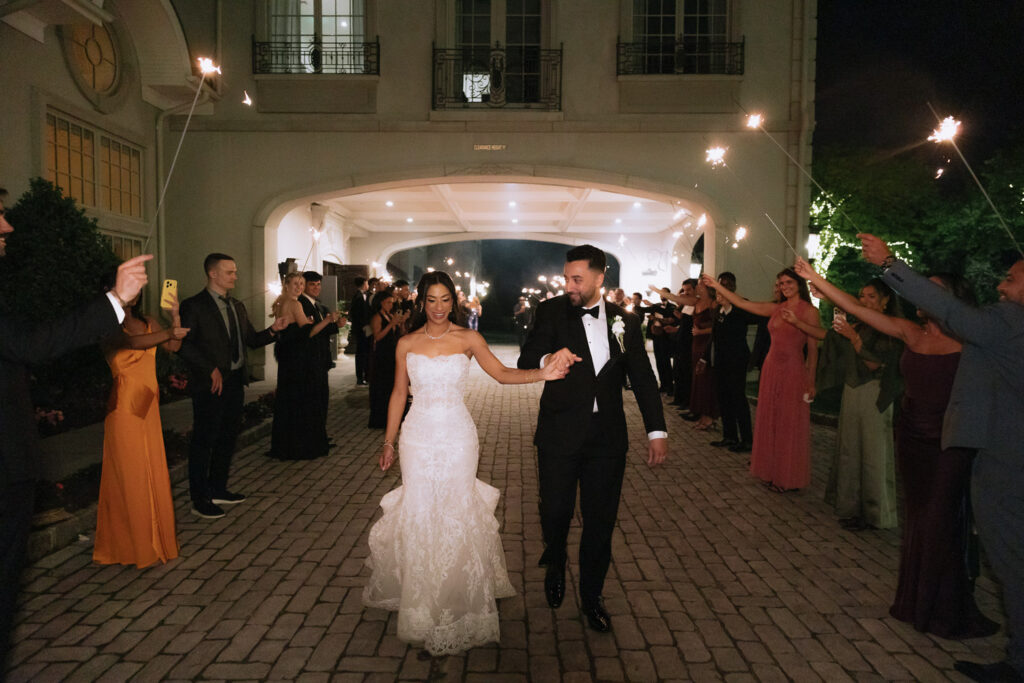 Menah and Ashraf walk through a sparkler exit at their Park Château Estate wedding in New Jersey.