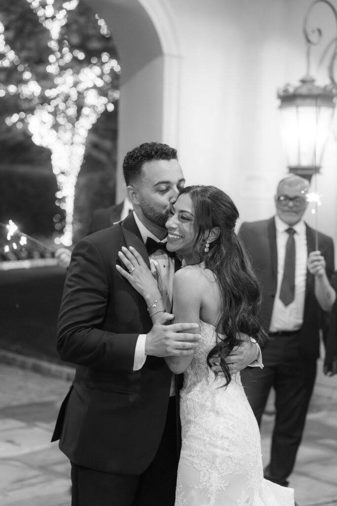 Groom Ashraf kisses his bride Menah on the forehead at their Park Chateau wedding in New Brunswick, NJ.