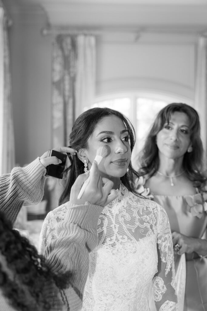 A bride gets her makeup touched up at the Park Chateau in East Brunswick, New Jersey.