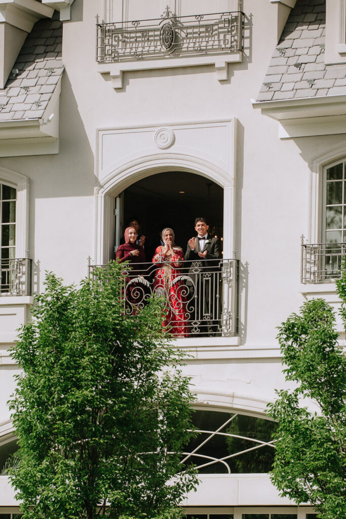 Wedding guests applaud from a balcony at Park Château Estate & Gardens in East Brunswick, New Jersey.