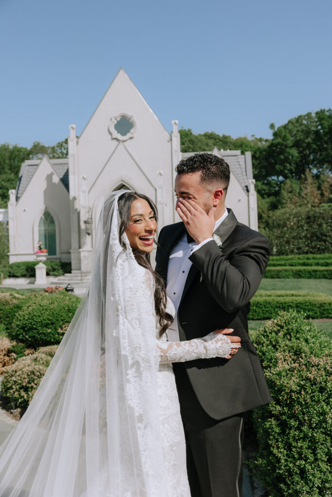 The bride laughs as the groom covers his mouth at their Park Chateau Estate & Gardens wedding.